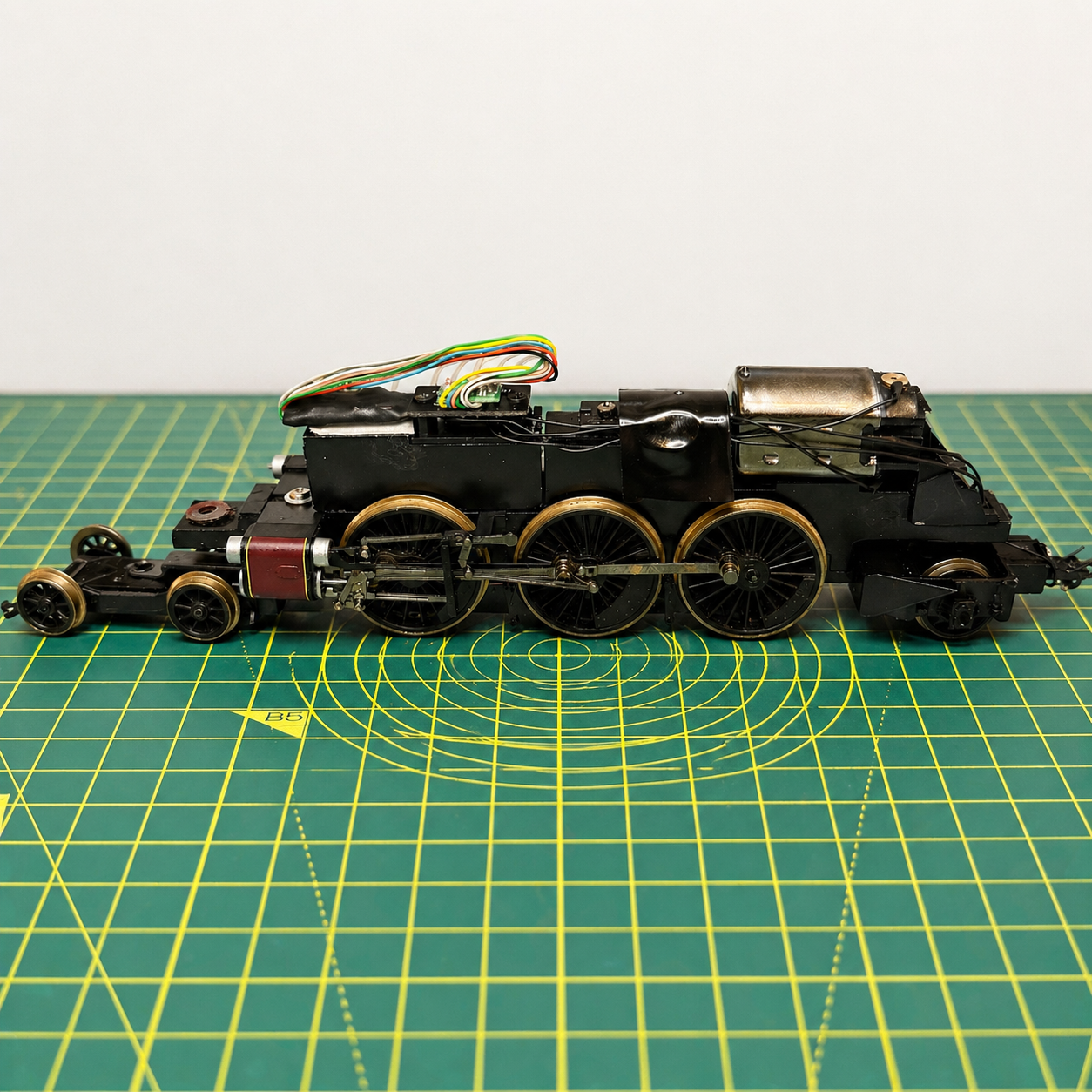 Model railway locomotive undergoing DCC conversion with wiring and decoder installation