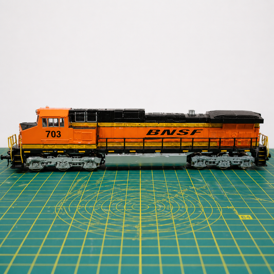 N gauge locomotive chassis undergoing repair and diagnostics on a model railway workbench
